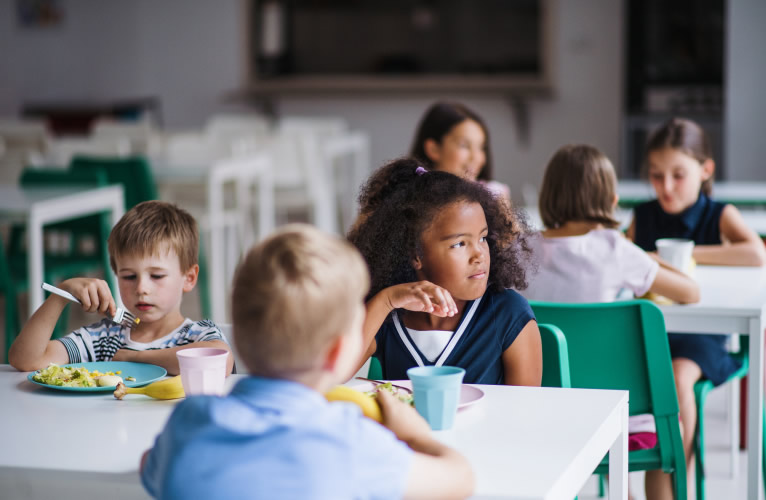 California School Lunch Group of cheerful school kids in canteen